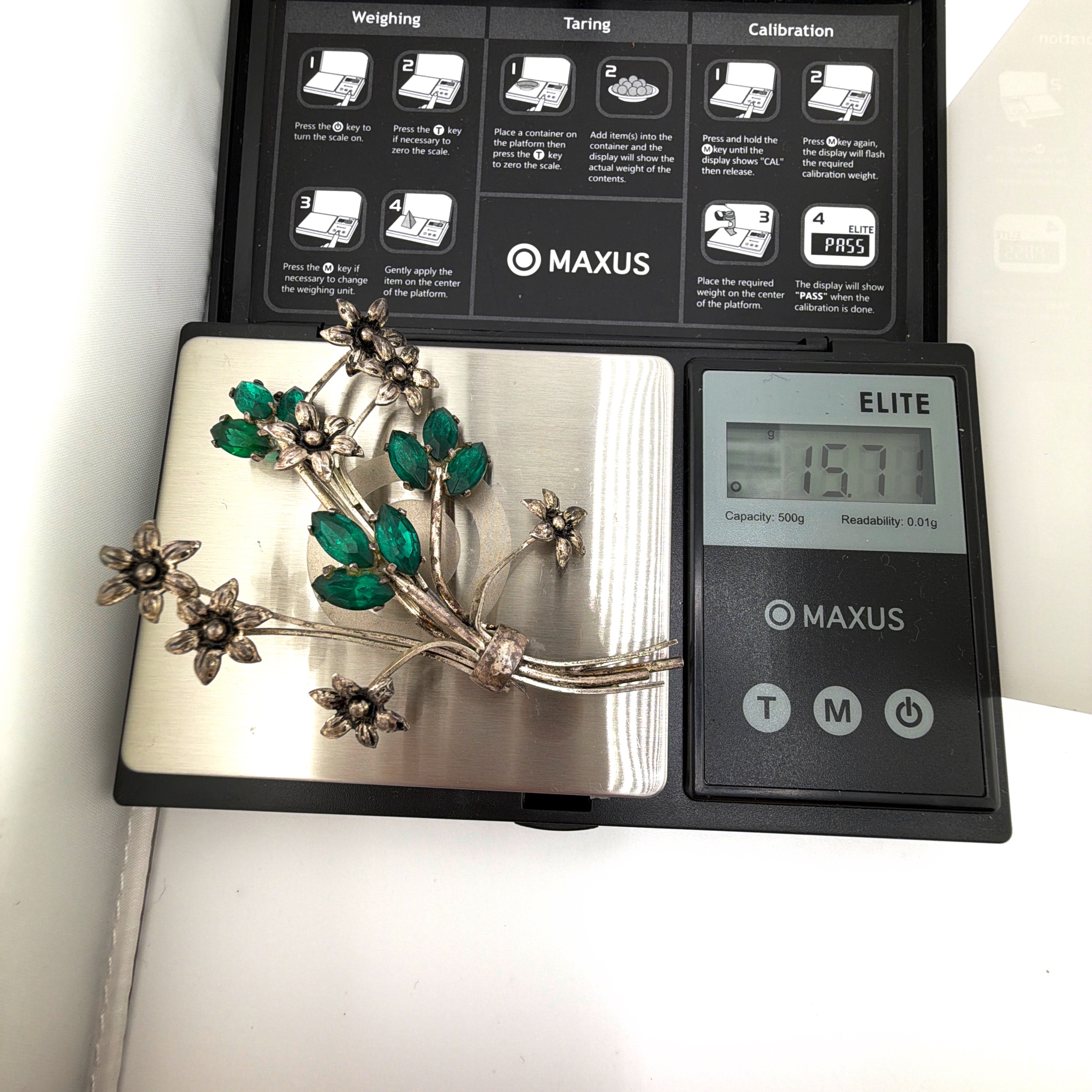 Retro 30s–50s Silver Tone Green Rhinestone Floral Spray Brooch 15.71g 2.75 in — For scale